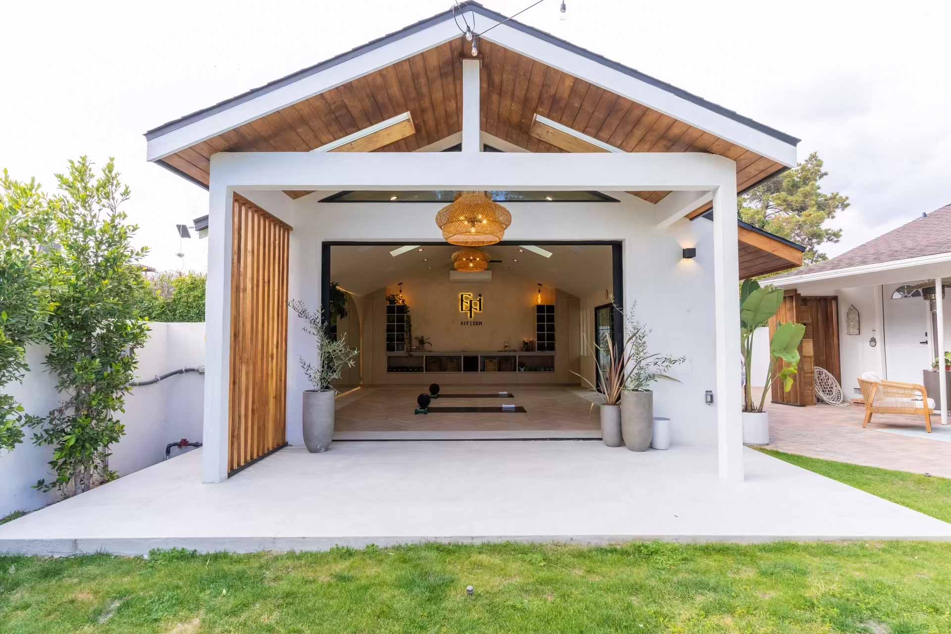 Modern ADU with exposed wood beam ceiling, open-air design, cedar slat details, and seamless indoor-outdoor flow - New Dawn Construction